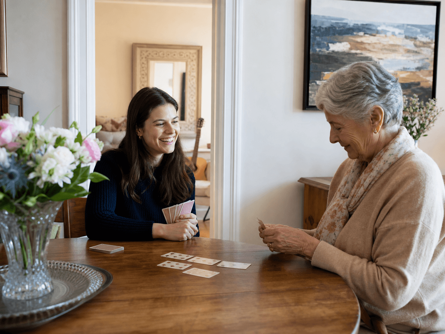 Companion and older adult playing cards at home